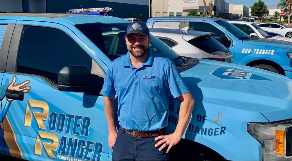 A Plumber from Rooter Ranger Standing by a Truck